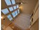 A spacious living room with high ceilings, large windows, and a fireplace, shot from above at 518 Zircon Way, Superior, CO 80027