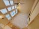 High angle view of a large living room with a cozy fireplace and filled with natural light from tall windows at 518 Zircon Way, Superior, CO 80027