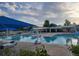 Community pool offers a refreshing escape with shaded seating and a diving board at 518 Zircon Way, Superior, CO 80027