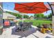 Inviting backyard with a large patio, umbrella, and a well-manicured lawn at 9264 Fox Fire Ln, Highlands Ranch, CO 80129