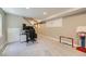 Finished basement features a gaming area, workspace, and neutral carpeting at 9264 Fox Fire Ln, Highlands Ranch, CO 80129