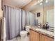 Bathroom featuring a granite countertop, coordinated fixtures, and a shower with curtain at 9264 Fox Fire Ln, Highlands Ranch, CO 80129