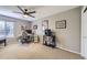 Comfortable bedroom featuring a ceiling fan, neutral tones, and a dedicated desk setup at 9264 Fox Fire Ln, Highlands Ranch, CO 80129