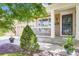 Close-up of front porch with white railings and decorative plants, creating a welcoming entrance at 9264 Fox Fire Ln, Highlands Ranch, CO 80129