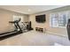 Basement gym featuring fitness equipment, natural light, and a mounted TV at 9264 Fox Fire Ln, Highlands Ranch, CO 80129