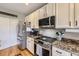 Stylish kitchen featuring stainless steel appliances, granite countertops, and ample cabinet space at 9264 Fox Fire Ln, Highlands Ranch, CO 80129