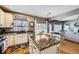 Bright eat-in kitchen features granite counters, stainless appliances, and an open floor plan to the living area at 9264 Fox Fire Ln, Highlands Ranch, CO 80129