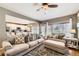 Spacious living room with hardwood floors, a large window, and an open floor plan to the kitchen at 9264 Fox Fire Ln, Highlands Ranch, CO 80129