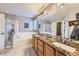 A spacious main bathroom offers a double vanity, a large mirror, a soaking tub, and a walk-in shower at 9264 Fox Fire Ln, Highlands Ranch, CO 80129