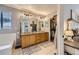 A luxurious main bathroom includes a double vanity, a large mirror, and a walk-in closet at 9264 Fox Fire Ln, Highlands Ranch, CO 80129