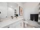 Bathroom with modern fixtures including white cabinetry, stone countertops, and a shower with white tile surround at 3011 W 53Rd Ave, Denver, CO 80221
