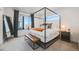 Primary bedroom boasting a four-poster bed, bench, and scenic views at 3011 W 53Rd Ave, Denver, CO 80221