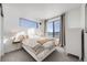 Bright bedroom featuring white walls, large windows, and a comfortable queen-sized bed at 3011 W 53Rd Ave, Denver, CO 80221