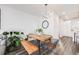 Bright dining area featuring a modern wooden table, stylish seating, and contemporary lighting fixture at 3011 W 53Rd Ave, Denver, CO 80221