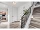 Hallway with modern staircase, showcasing clean lines and a view into a bright office space at 3011 W 53Rd Ave, Denver, CO 80221
