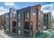 Modern townhome exterior showcasing its unique design and multiple levels with wood accents and balconies at 3011 W 53Rd Ave, Denver, CO 80221