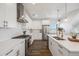 Bright and airy kitchen with stainless steel appliances, white cabinets, and quartz countertops at 3011 W 53Rd Ave, Denver, CO 80221