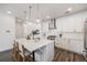 Bright and modern kitchen with white cabinets, a large island, and stainless steel appliances at 3011 W 53Rd Ave, Denver, CO 80221