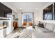 Bright living room features a modern fireplace, and comfortable seating for relaxing and entertaining at 3011 W 53Rd Ave, Denver, CO 80221