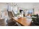 Bright living room with a staircase, a flat screen TV, and large windows offering natural light at 3011 W 53Rd Ave, Denver, CO 80221