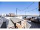Outdoor rooftop seating area with outdoor seating, a dining table, and string lights at 3011 W 53Rd Ave, Denver, CO 80221