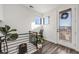 Upper level landing features a door to the outside and a charming seating area with natural light at 3011 W 53Rd Ave, Denver, CO 80221