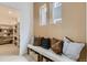 Bench in foyer, with decoratively placed pillows. Pantry shown to the left at 16947 W 92Nd Dr, Arvada, CO 80007