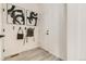 Clean entryway with light wood floors, artwork, and hooks for storage, offering a welcoming space at 16947 W 92Nd Dr, Arvada, CO 80007