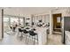 Modern kitchen with large island, sleek countertops, and stainless steel appliances at 16947 W 92Nd Dr, Arvada, CO 80007