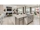 Open concept kitchen with a large island and adjacent living area, ideal for entertaining at 16947 W 92Nd Dr, Arvada, CO 80007