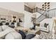 Bright and airy living room with high ceilings, modern decor, and open floor plan to kitchen and dining at 16947 W 92Nd Dr, Arvada, CO 80007
