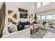 Spacious living room featuring large windows, contemporary furniture, and stylish decor at 16947 W 92Nd Dr, Arvada, CO 80007