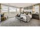 Serene main bedroom with large windows, plush carpet, and sophisticated decor at 16947 W 92Nd Dr, Arvada, CO 80007