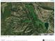 Aerial view of the surrounding neighborhood, a golf course, and winding roads with surrounding greenery at 6619 Apache Pl, Larkspur, CO 80118