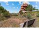 Scenic backyard with wooden bench and beautiful view of unique rock formation at 6619 Apache Pl, Larkspur, CO 80118