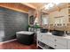 Modern bathroom with standalone tub, geometric wallpaper, wood ceiling and dual vanity at 6619 Apache Pl, Larkspur, CO 80118