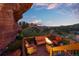 Deck with outdoor seating and fire pit nestled amongst rock formations offering scenic views at dusk at 6619 Apache Pl, Larkspur, CO 80118