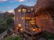 Unique home with an outdoor deck with fire pit nestled against a natural rock formation at 6619 Apache Pl, Larkspur, CO 80118