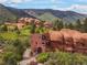 Exterior of modern luxury home built alongside gorgeous sandstone rock formations at 6619 Apache Pl, Larkspur, CO 80118