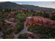 Stunning modern home seamlessly integrated with natural rock formations in a picturesque landscape at 6619 Apache Pl, Larkspur, CO 80118