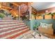 Unique home interior featuring stone stairs and lush greenery around an impressive rock formation at 6619 Apache Pl, Larkspur, CO 80118