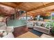 Comfortable living room featuring wood beam ceiling, hardwood floors, and stair access at 6619 Apache Pl, Larkspur, CO 80118