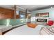 Bright main bedroom with wood floors, rock wall, fireplace, and plenty of natural light at 6619 Apache Pl, Larkspur, CO 80118