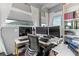 Functional home office with a built-in desk, shelving, natural light, and views at 6619 Apache Pl, Larkspur, CO 80118