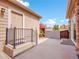 Back deck and door leading to house surrounded by colorful foliage at 22898 E Ottawa Pl, Aurora, CO 80016