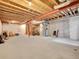 Unfinished basement with exposed wooden beams ready to be customized at 22898 E Ottawa Pl, Aurora, CO 80016