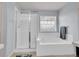 Bathroom showcasing a glass shower, soaking tub, and natural light at 22898 E Ottawa Pl, Aurora, CO 80016