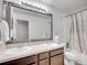 Bright bathroom featuring double sinks, large mirror and shower with curtain at 22898 E Ottawa Pl, Aurora, CO 80016