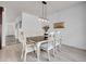 Elegant dining room featuring a stylish table set, modern lighting, and pristine white walls at 22898 E Ottawa Pl, Aurora, CO 80016
