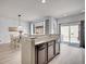 Open dining area with modern lighting, hardwood floors, and sliding glass door to outside at 22898 E Ottawa Pl, Aurora, CO 80016